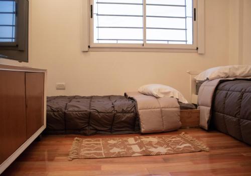 a living room with a couch and a window at Ayres de Saavedra - Dot Baires Shopping in Buenos Aires
