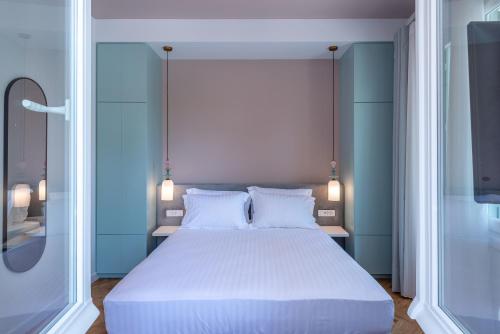 a bedroom with a large white bed with two pillows at Casa Navarino by Immobilis in Nafplio