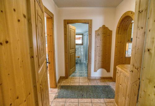 a hallway of a home with wooden walls and doors at Appartments Geisler in Achenkirch