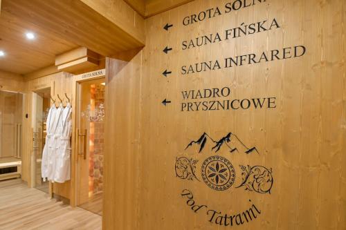 a wall in a store with signs on it at Pod Tatrami 1 - świetna lokalizacja - sauna infared oraz grota solna - jedno wejście gratis in Białka Tatrzańska