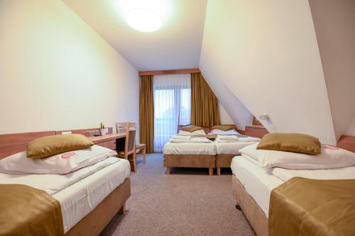 Ένα ή περισσότερα κρεβάτια σε δωμάτιο στο Pod Tatrami 1 - świetna lokalizacja - sauna infared oraz grota solna - jedno wejście gratis