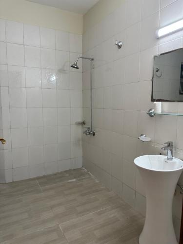 a bathroom with a toilet and a sink and a mirror at Askin Presdential 41 in Islamabad