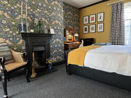 a bedroom with a bed and a fireplace at One Drake Road, Tavistock, Devon in Tavistock
