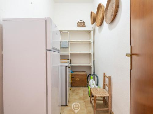 a room with a refrigerator and a table and chairs at Marine View House in Putzu Idu