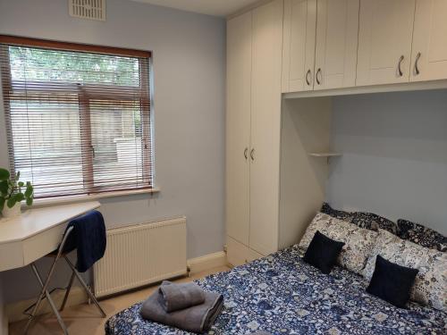 a bedroom with a bed and a desk and a window at Remarkable 1-Bed Apartment in North London N8 in London