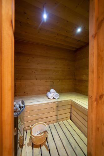 a wooden sauna with a chair and towels in it at Le Bûcher d'Albert in Champagny-en-Vanoise