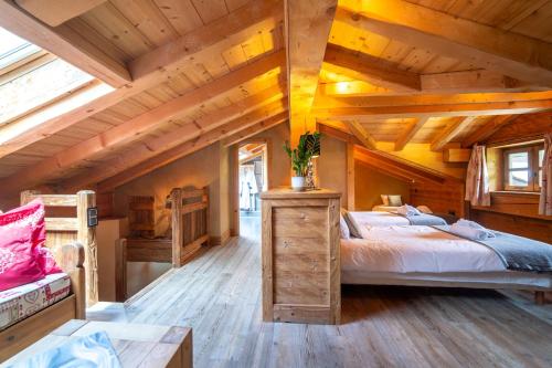 a bedroom with a large bed and wooden ceilings at Le Bûcher d'Albert in Champagny-en-Vanoise