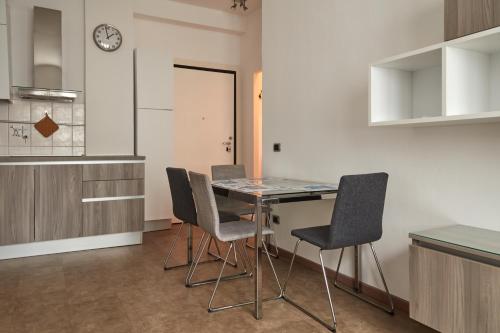 a kitchen with a table and chairs in a room at Hotel Lido in Milan
