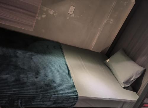 a small bed in a small room at T Zone Hostel - Quiet Place, Near China Town,Ho Thi Ky Street Food,Cafe,Beer in Ho Chi Minh City