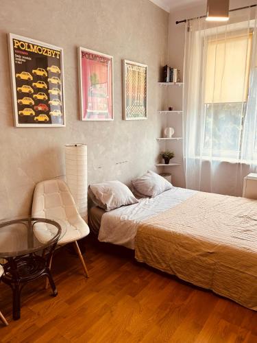 a bedroom with two beds and a table and a chair at KR Apartament in Krakow