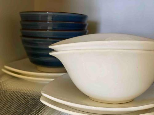 a group of bowls and plates on a table at 3BR 8PAX KL City Centre KLCC View Ampang Boulevard Condo in Ampang