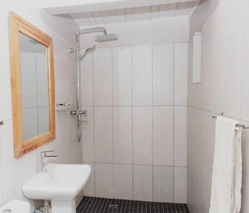 a bathroom with a sink and a toilet and a mirror at Paphiri House in Zomba