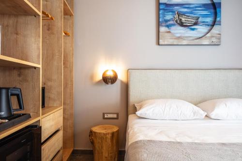 a bedroom with a bed and a tv and a table at Skipper Beachfront Suites in Hersonissos