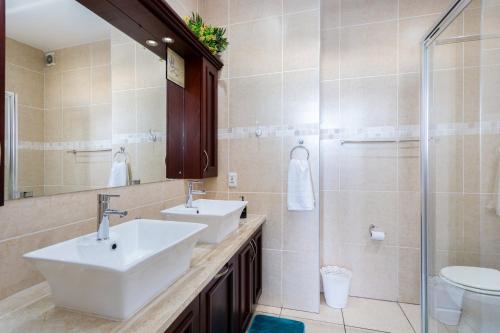 a bathroom with two sinks and a shower at Colonial Sands 403 in Margate