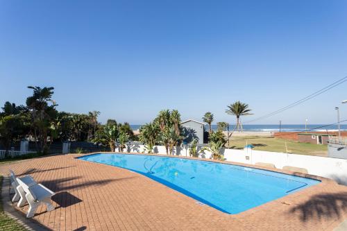 a swimming pool with a view of the beach at Colonial Sands 403 in Margate