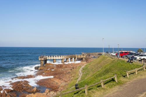 a pier with cars parked next to the ocean at Colonial Sands 403 in Margate