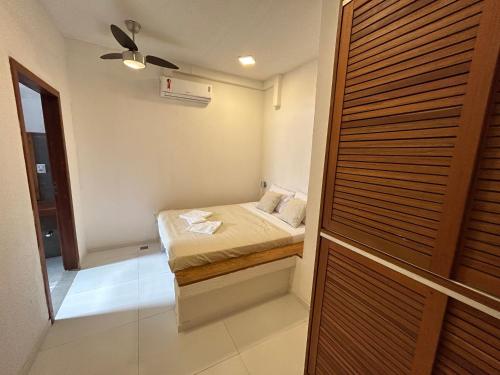a small bedroom with a bed and a closet at PIPA BAVARIA BEIRA MAR in Pipa
