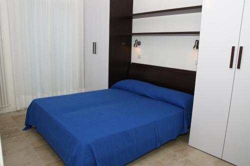 Giường trong phòng chung tại Residence Mediterranee Family Apartments