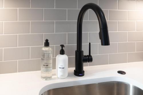 a sink with two bottles of soap next to it at Sosuite at French Quarters - Rittenhouse Square in Philadelphia