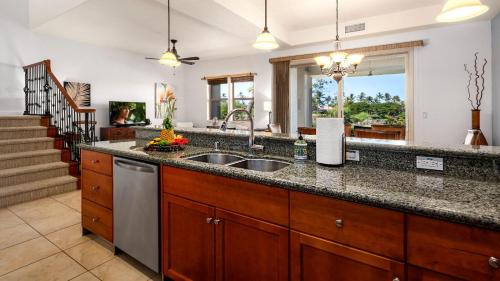a kitchen with a sink and a counter at Mauna Lani Fairways 903 in Waikoloa