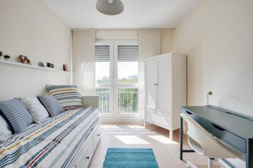 Schlafzimmer mit einem Bett und einem Schreibtisch in der Unterkunft Escapade sur l'île de Nantes avec vue sur la Loire in Nantes