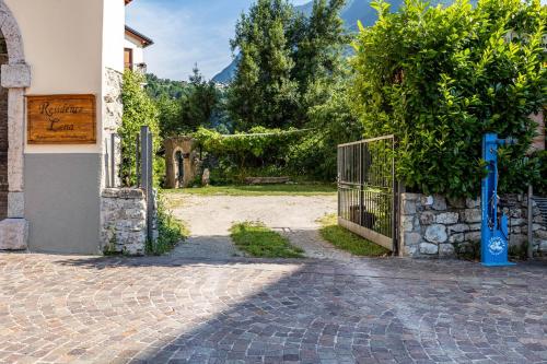 an entrance to a house with a gate and a brick driveway at Residence Lena App 3 with Balcony in Tenno