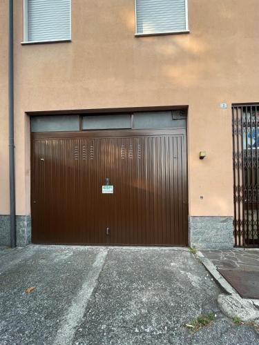 a brown garage door on the side of a building at GreatLakeMountainView in Vercurago