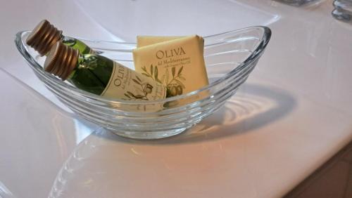 a glass bowl with a bottle of wine on a table at Barwny Zakątek in Augustów