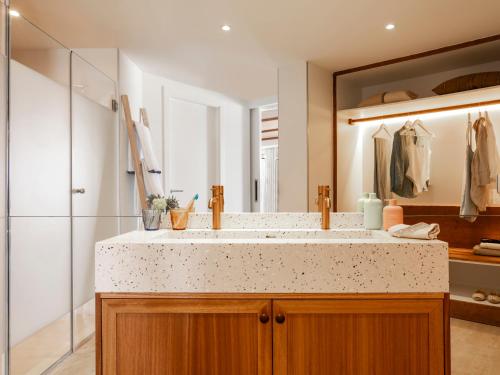 a bathroom with a sink and a large mirror at Zel Mallorca in Palmanova