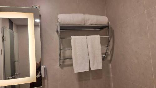 a bathroom with towels hanging on a wall at B303-Nice Seaview 1 Bedroom 300 meters walking To Ao Nang Beach in Ao Nang Beach