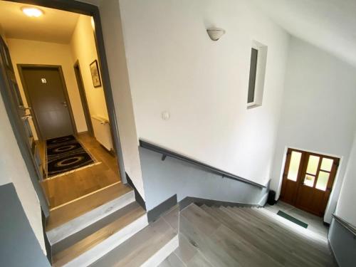 an empty hallway with a stairway leading to a room at Soba za goste Kraljica 3 in Kupres