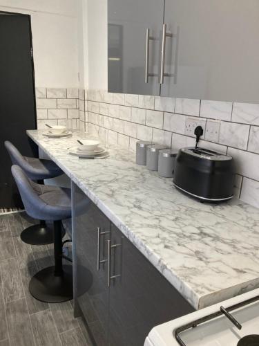 a kitchen with a counter with a pot on it at Apartment 8 - Luxury Living & free parking in Nottingham