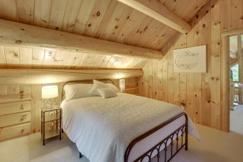 a bedroom with a bed in a wooden cabin at Alexandria Cabin with Patio, Grill and Deck in South Alexandria