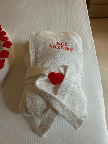 a white towel with a heart on it on a bed at B&B Baciami Ancora in Bari