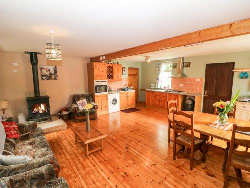 a large living room with a table and a fireplace at Teach Chiuin in Boheravaghera Cross Roads