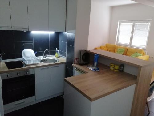 a small kitchen with a sink and a counter at One bedroom apartment-Centar in Kavadarci