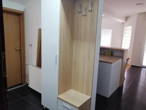 a kitchen with a wooden door and a counter at One bedroom apartment-Centar in Kavadarci