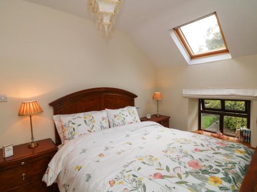 a bedroom with a bed and two windows at Toberlonagh 