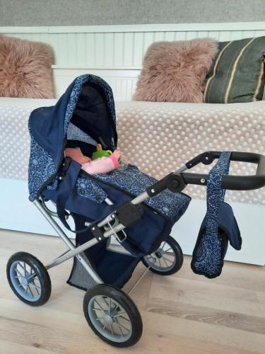 a baby stroller sitting next to a couch at Aalto 17 in Haapsalu
