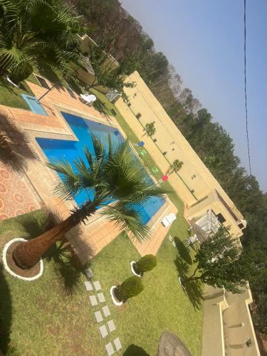 an overhead view of a swimming pool with palm trees at Stunning 3-Bed Villa in Fes near fes sais airport in Fès