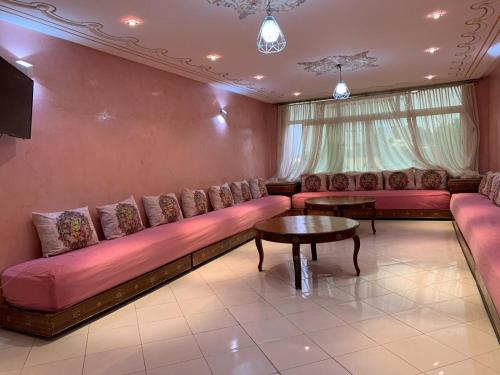 een woonkamer met een bank en een tafel bij Stunning 3-Bed Villa in Fes near fes sais airport in Fès
