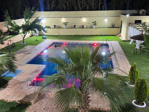 a swimming pool in a backyard at night at Stunning 3-Bed Villa in Fes near fes sais airport in Fès