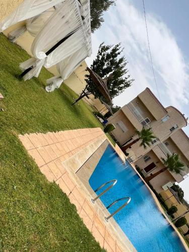 a swimming pool in front of a house at Stunning 3-Bed Villa in Fes near fes sais airport in Fès