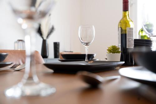 a table with a plate and a bottle of wine at Escape Ordinary at Lily's Pad in Enniskillen