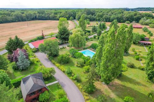 an aerial view of a home with a driveway and trees at Les Cabanes Parisiennes - Chalets 1h30 from Paris - 62P in Sainte-Geneviève-des-Bois