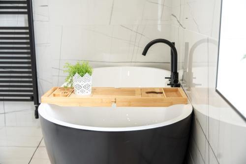 a bathroom with a bath tub with a faucet at Escape Ordinary at Lily's Pad in Enniskillen
