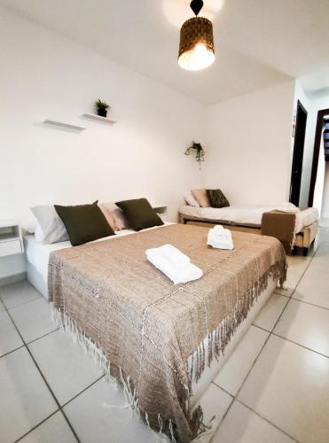 a living room with a bed and a couch at Casa com vista mar in Pipa