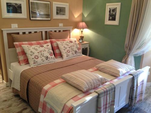a bedroom with a large bed with pillows at Zia Letizia Bed And Wine in Monterosso al Mare