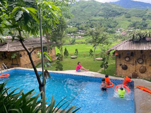 a group of children playing in a swimming pool at Sapa Bamboo Eco in Sa Pa