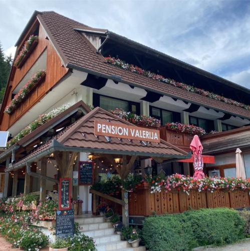 a building with a sign that reads pension valey at Penzion Valerija in Zgornje Jezersko